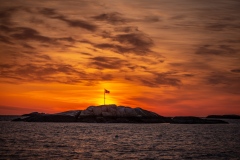 Sunrise over the flag on Minot Beach.